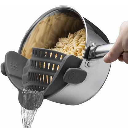 Clip-on silicone pot strainer attached to the rim of a cooking pot